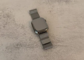 Apple Watch with Milanese loop on a light stone surface, related to the Apple Watch Series 12 code findings
