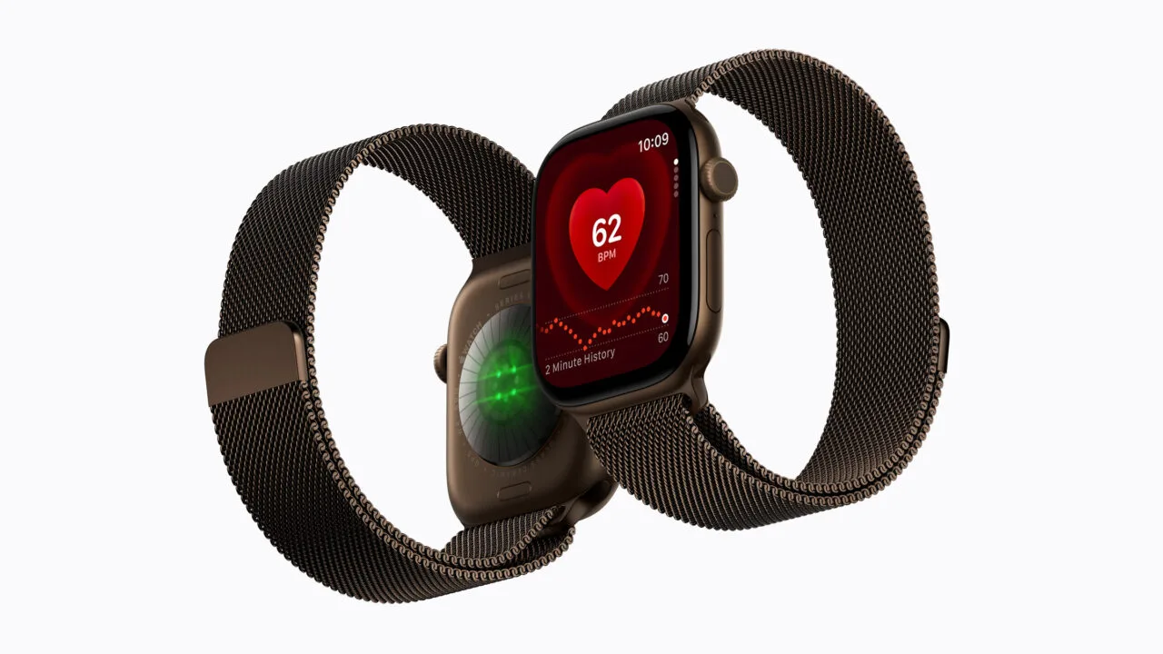 Apple Watch Series 12 with Milanese band, heart rate shown on the watch face and the glowing heart sensor on the back
