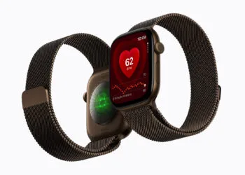 Apple Watch Series 12 with Milanese band, heart rate shown on the watch face and the glowing heart sensor on the back