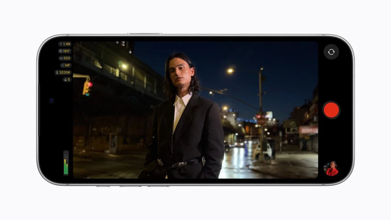 Final Cut Camera on an iPhone 18 Pro in landscape showing an f/1.48 aperture while filming a man at night on a city street