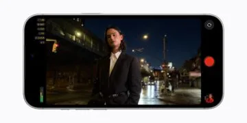 Final Cut Camera on an iPhone 18 Pro in landscape showing an f/1.48 aperture while filming a man at night on a city street
