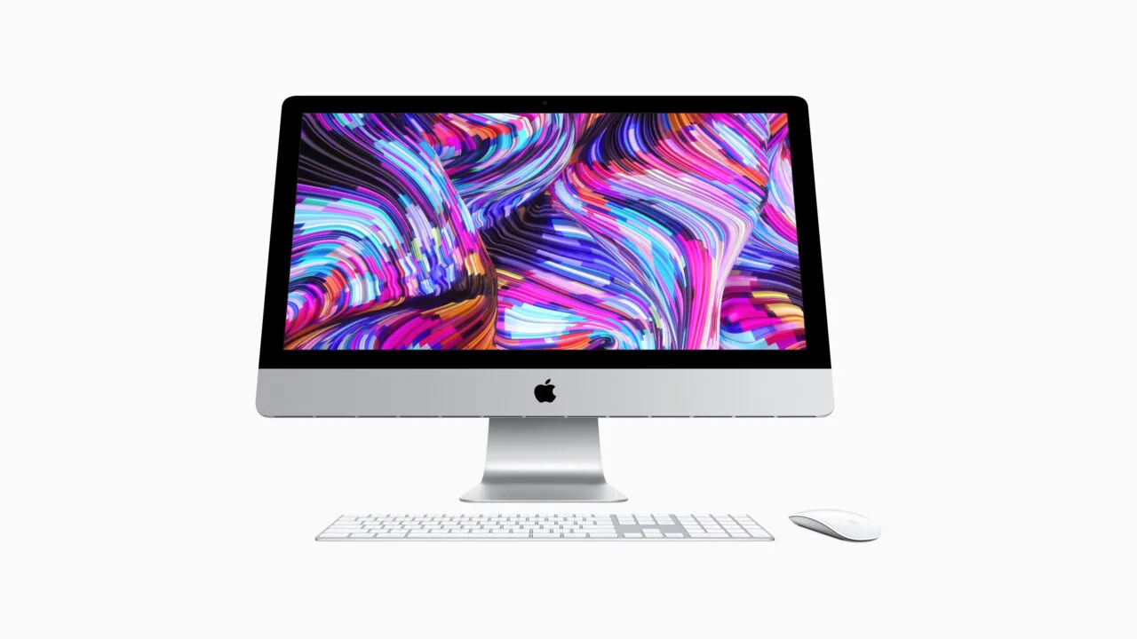 Vintage iMac model, front view with keyboard and mouse