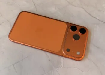 Camera module of an orange iPhone, related to the iOS 27 camera features found in code