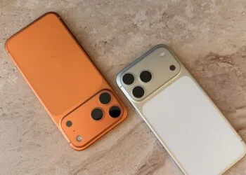 Two iPhones side by side on light marble as iPhone Handoff runs both under one phone number