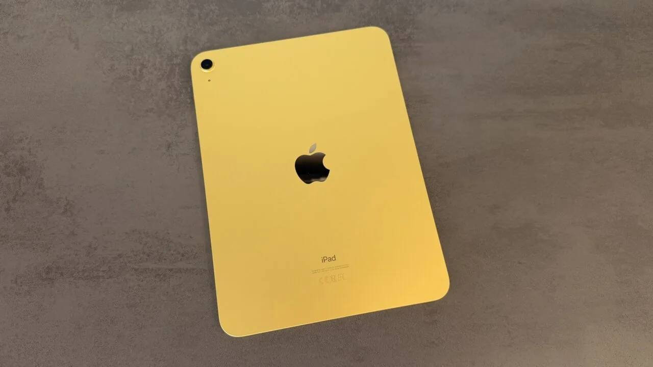 Yellow entry-level iPad seen from the back on a grey stone surface – for the code finding on the iPad mini 8 and iPad 12