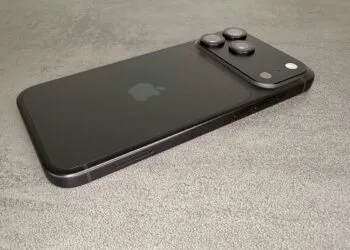 Black iPhone 18 Pro from the back with camera plateau on a grey stone surface – one of the devices for which users report iPhone 18 Pro reboots