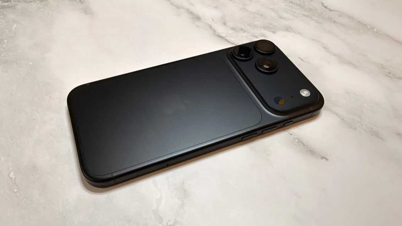 Black iPhone 18 Pro Max seen from the back on light marble, focusing on the camera system whose white balance and shutter speed can now be controlled manually on the iPhone 18 Pro