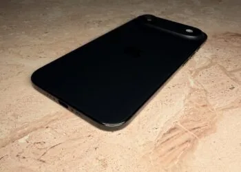 iPhone roadmap: a black iPhone lying face down on a light stone surface