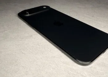 iPhone Ultra market share: black iPhone Air lying flat, viewed from the side on light stone