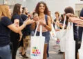 Customer holding a tote bag in an Apple Store, where the iPhone Ultra price will be put to the test