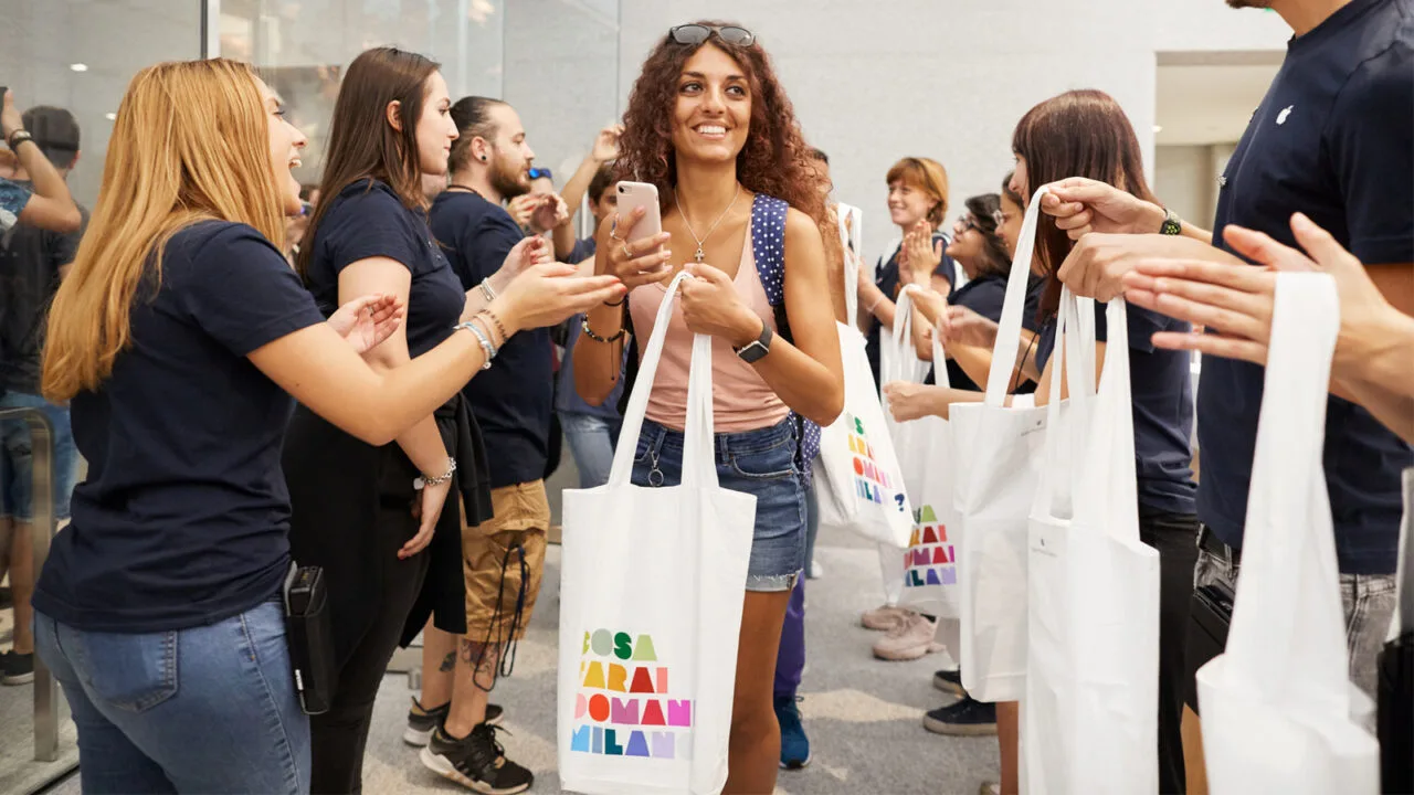 Customer holding a tote bag in an Apple Store, where the iPhone Ultra price will be put to the test