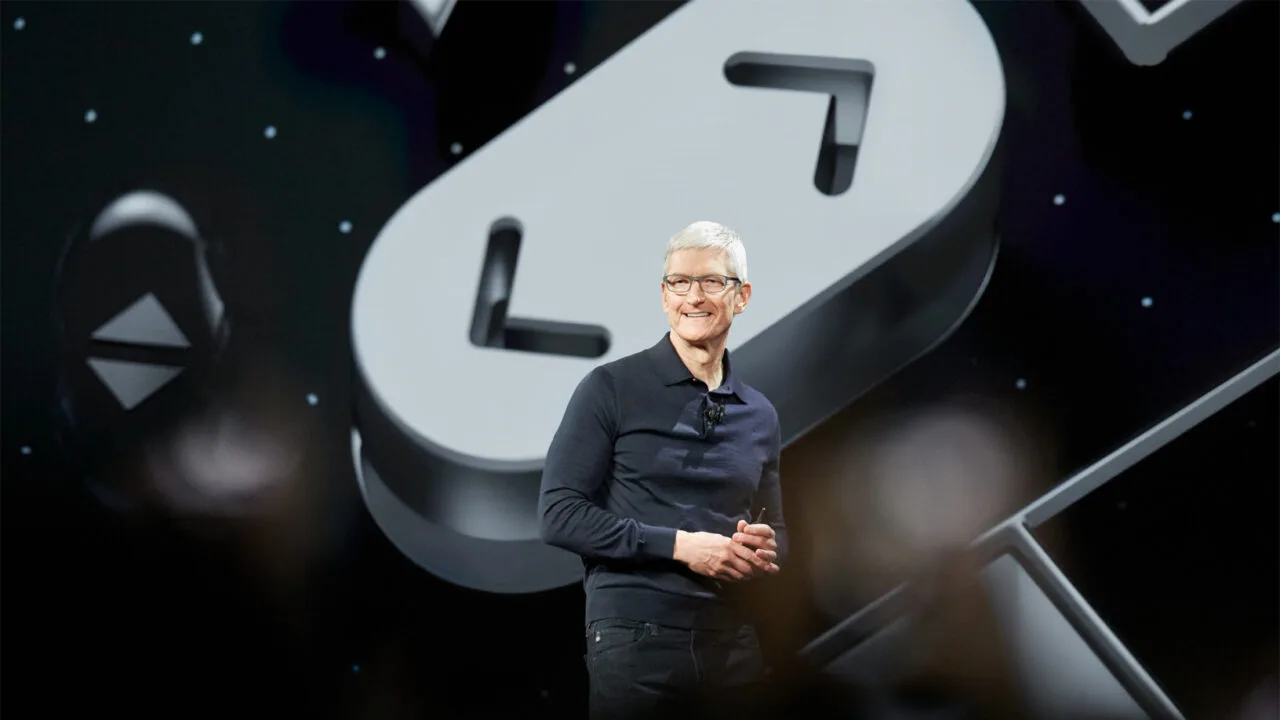 iPhone Ultra Tim Cook: Apple CEO on a keynote stage in front of a large clock symbol