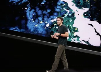 New Apple CEO John Ternus speaking on a keynote stage in front of a large projection