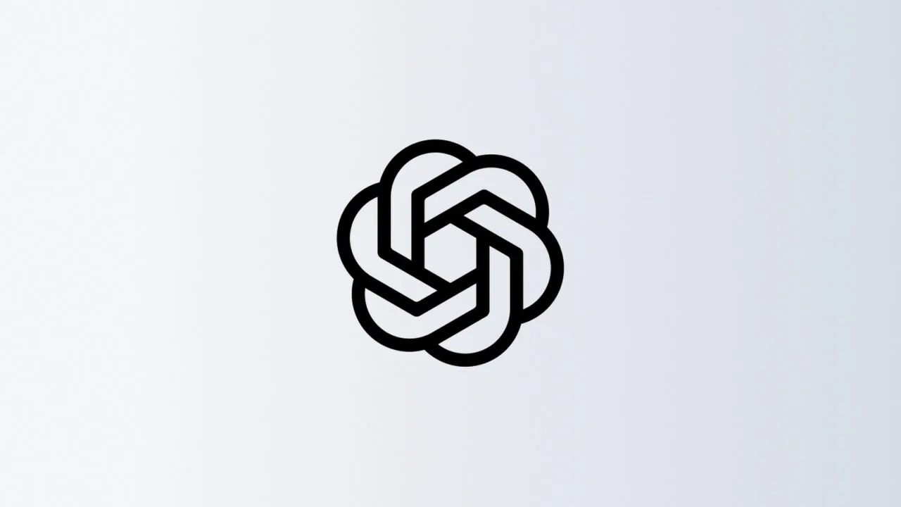 OpenAI pauses training: black OpenAI blossom on a light grey gradient