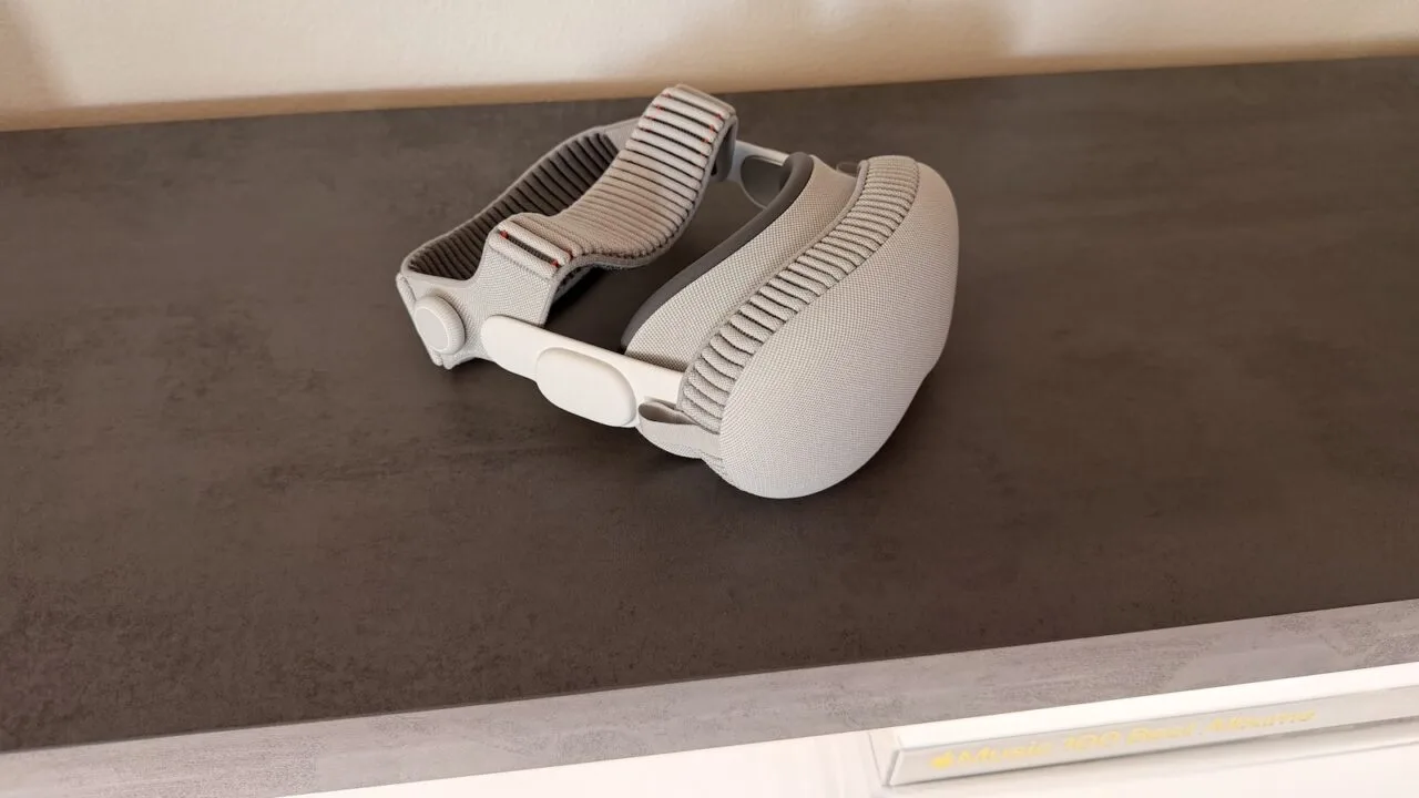 Apple Vision Pro with head strap on a dark surface as the Vision Pro job cuts reach further teams