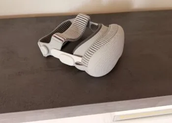 Apple Vision Pro with head strap on a dark surface as the Vision Pro job cuts reach further teams