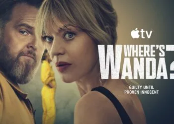 Where's Wanda season 2: Axel Stein and Heike Makatsch looking over their shoulders, a figure in a yellow suit behind them