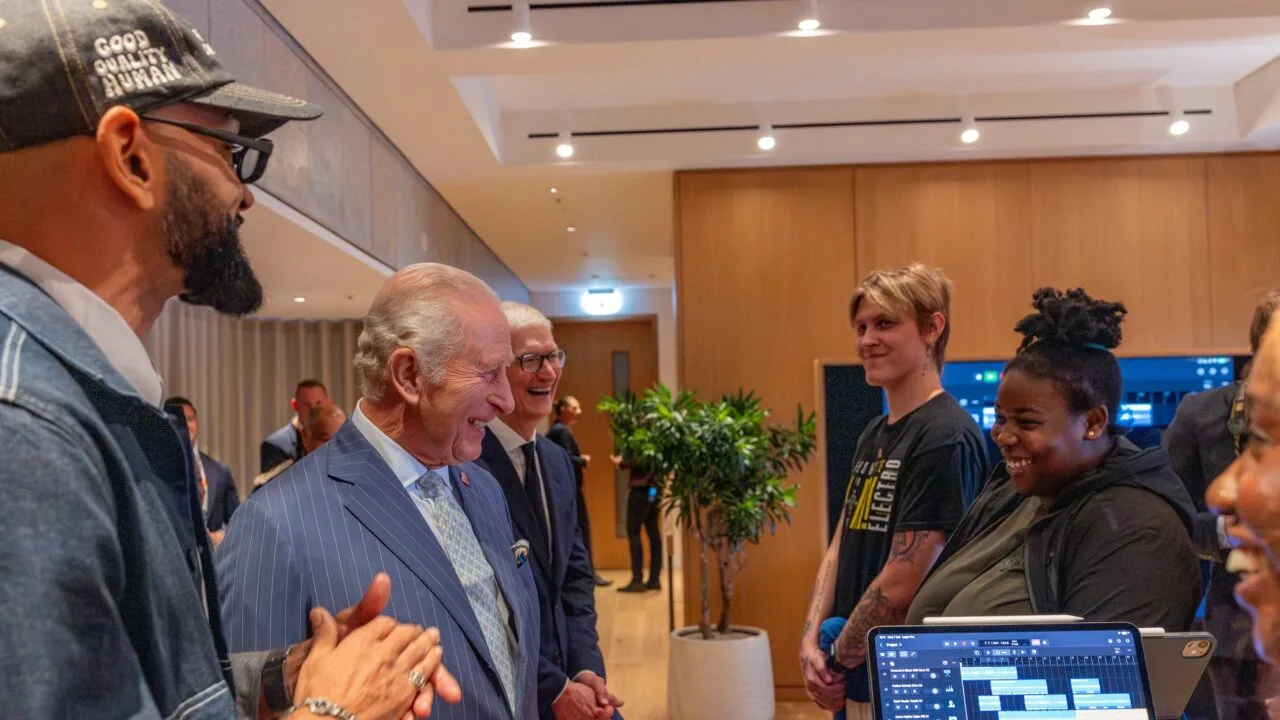 Apple King's Trust: King Charles III and Tim Cook talking with Creative Labs participants, an iPad running Logic Pro in front