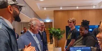 Apple King's Trust: King Charles III and Tim Cook talking with Creative Labs participants, an iPad running Logic Pro in front
