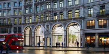 Apple Store Regent Street in London at dusk with four glass arches, a white Apple flag and a red double-decker bus, representing the Apple Stores that received boxes with an embargo date