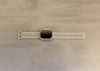 Apple Watch Ultra 4 with a grey Ocean Band on a grey stone surface, whose sensor technology is at the centre of the legal dispute between Apple and Oppo