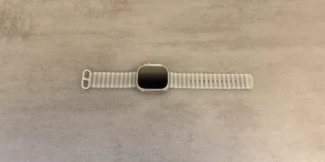 Apple Watch Ultra 4 with a grey Ocean Band on a grey stone surface, whose sensor technology is at the centre of the legal dispute between Apple and Oppo