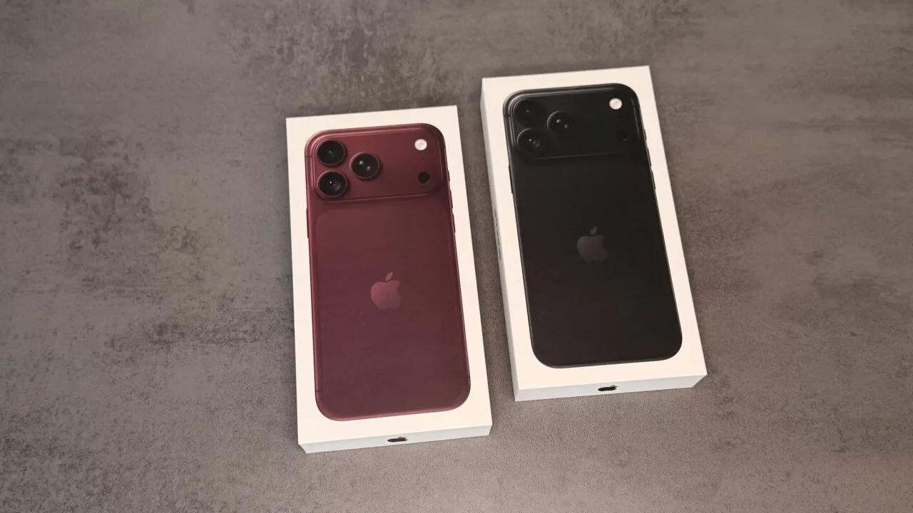 Two iPhone 18 Pro boxes in burgundy and black on a grey surface