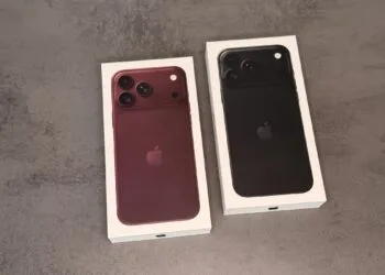 Two iPhone 18 Pro boxes in burgundy and black on a grey surface