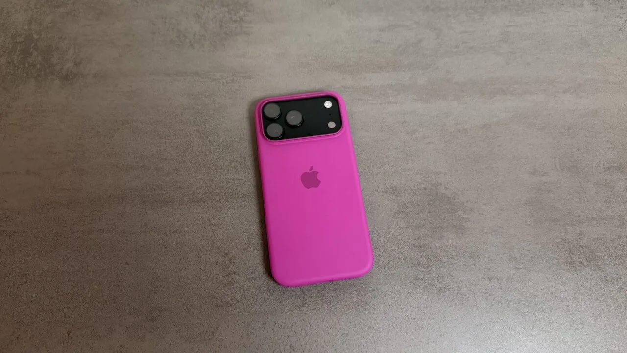 An iPhone 18 Pro series model in a pink silicone case on a grey stone surface; the series put Apple first in China