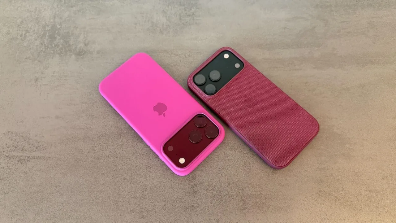 iPhone market share: two iPhone 18 Pro Max in pink and berry-red cases on a grey stone surface
