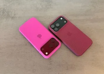 iPhone market share: two iPhone 18 Pro Max in pink and berry-red cases on a grey stone surface
