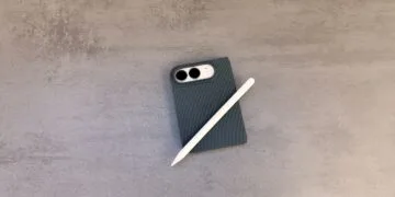 Folded iPhone Duo in a dark case on a grey stone surface with a white Apple Pencil on top – iPhone Duo with Apple Pencil