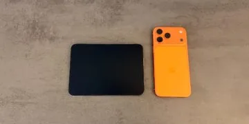 iPhone Duo unfolded next to an orange iPhone 17 Pro Max, a first impression of the difference in display size