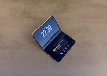 iPhone Duo display crack: an intact, half-unfolded iPhone Duo on a stone surface, the crease of the inner display showing as a light stripe in the light