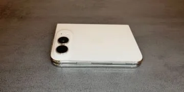 iPhone Duo camera preview: the folded white iPhone Duo lies on a grey table with its two rear cameras in the top left