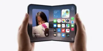 Unfolded iPhone Duo held in landscape with both hands showing the Home Screen, Apple is said to raise iPhone Duo production