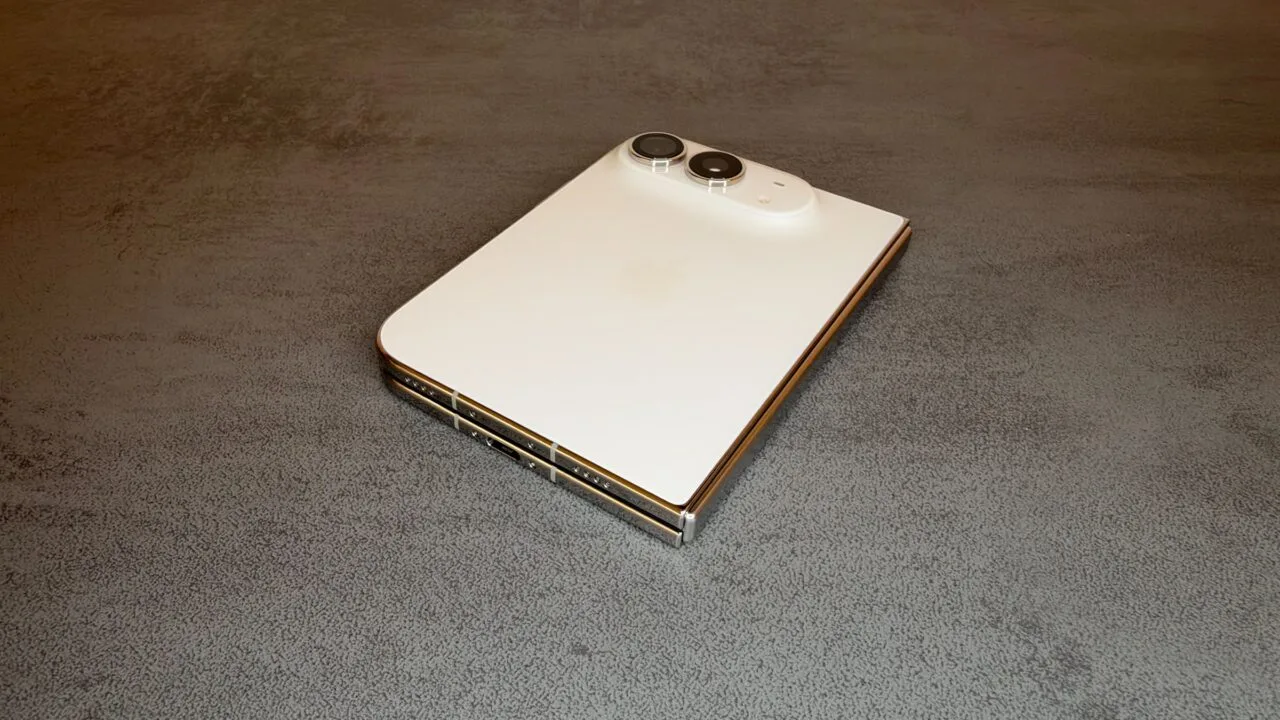 For the iPhone Duo repair manual: the folded iPhone Duo in Star White on a table, showing the back glass, camera, hinge and USB-C port.
