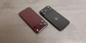 JP Morgan raises its Apple price target despite reported iPhone 18 Pro cuts: two Pro models in burgundy and black seen from the back on a grey stone surface