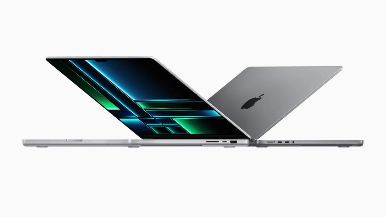 Two open MacBook Pro in silver and space gray, one facing the display – the MacBook Pro is expected to get an OLED display next