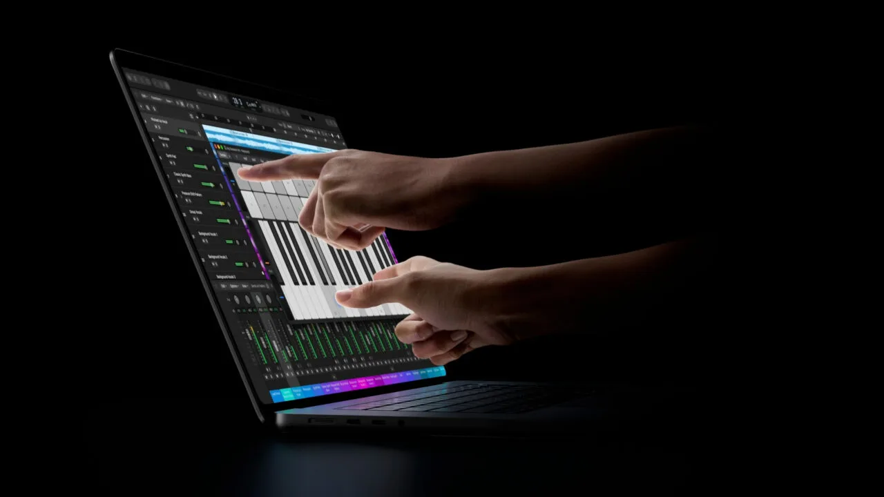 MacBook Pro touch: two hands playing an on-screen keyboard in Logic Pro on the display of a MacBook Pro with PROLED XDR Display