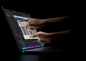 MacBook Pro touch: two hands playing an on-screen keyboard in Logic Pro on the display of a MacBook Pro with PROLED XDR Display