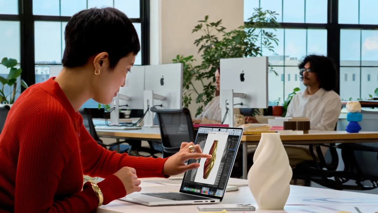 MacBook Pro touch: a woman taps the display of a MacBook Pro to work on a 3D model of a vase