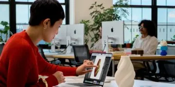 MacBook Pro touch: a woman taps the display of a MacBook Pro to work on a 3D model of a vase
