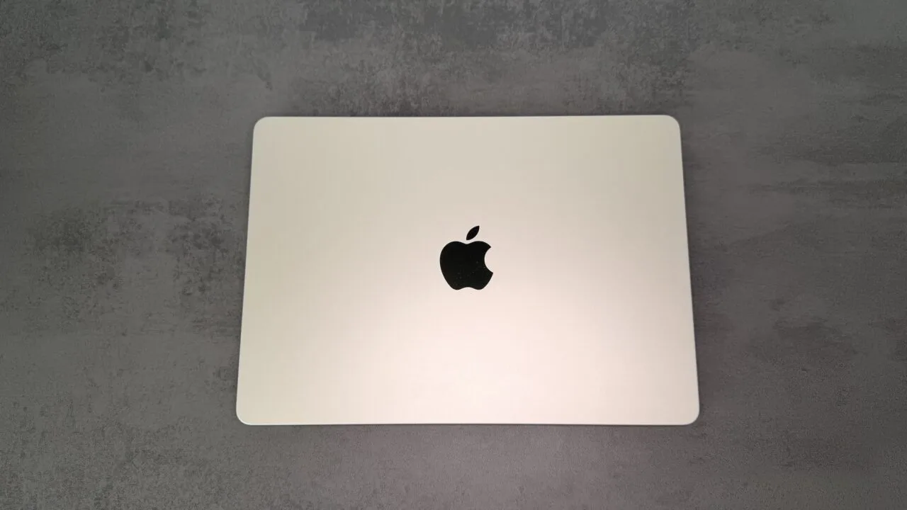 Closed silver MacBook seen from above on a grey stone surface, ahead of the MacBook Ultra with OLED touch display, which has not yet been announced