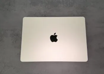 Closed silver MacBook seen from above on a grey stone surface, ahead of the MacBook Ultra with OLED touch display, which has not yet been announced