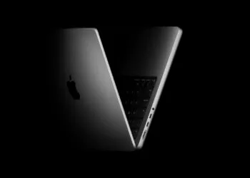 Half-open 14-inch MacBook Pro against a black background – macOS 27.2 prepares touch gestures for the Mac