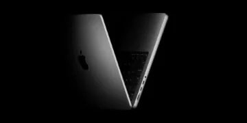 Half-open 14-inch MacBook Pro against a black background – macOS 27.2 prepares touch gestures for the Mac