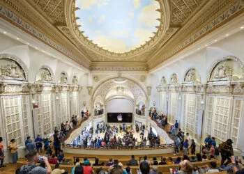 New Macs and iPad mini expected to be shown in Los Angeles: the Apple Tower Theatre store with its ornate dome, gallery and many visitors in front of the stage with the Apple logo
